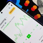 How Money Apps Are Changing Personal Finance for Millions of Americans Mobile screen displaying an investment app with a stock market graph