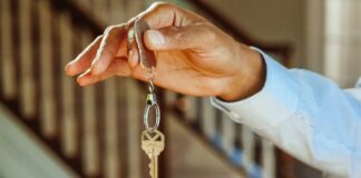 A hand holding a key on a keychain