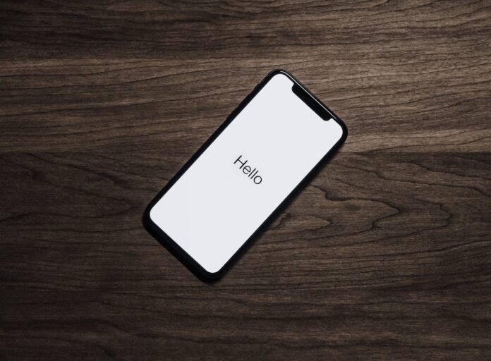 pexels-lastly-699122.jpg A smartphone displaying the word 'Hello' on a wooden table