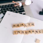 How Rising Deductibles Are Changing the Way People Use Health Insurance Scrabble tiles spelling 'HEALTH INSURANCE' on a planner